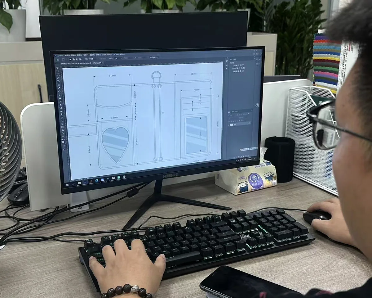 Custom bag specification and design review at Hongzhao Hongzhao bag designer reviewing a custom product structure drawing for an OEM and ODM buyer project