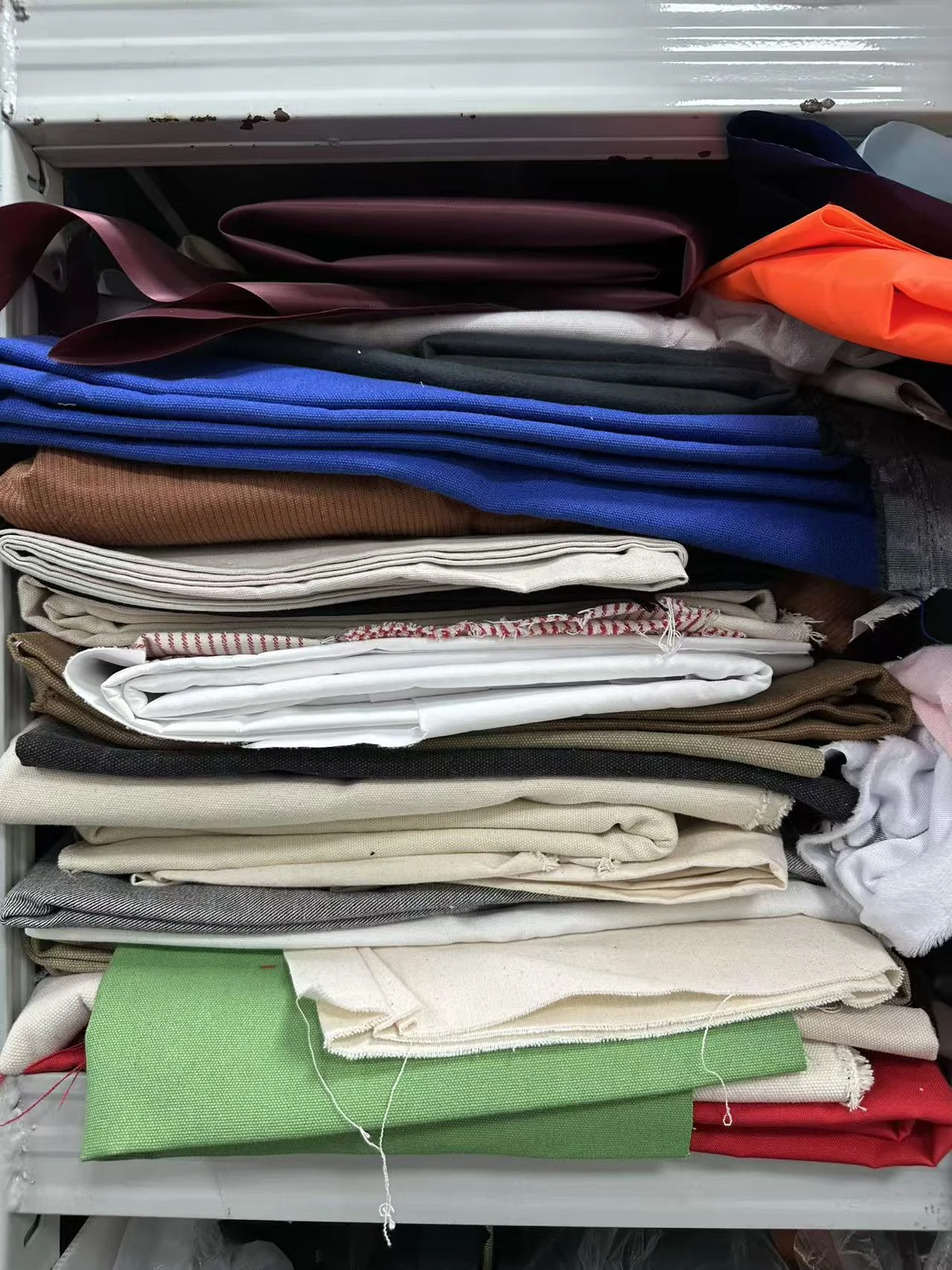 Real custom bag fabric, lining, webbing and component materials arranged for buyer review Real custom bag fabric, lining, webbing and component materials arranged for buyer review