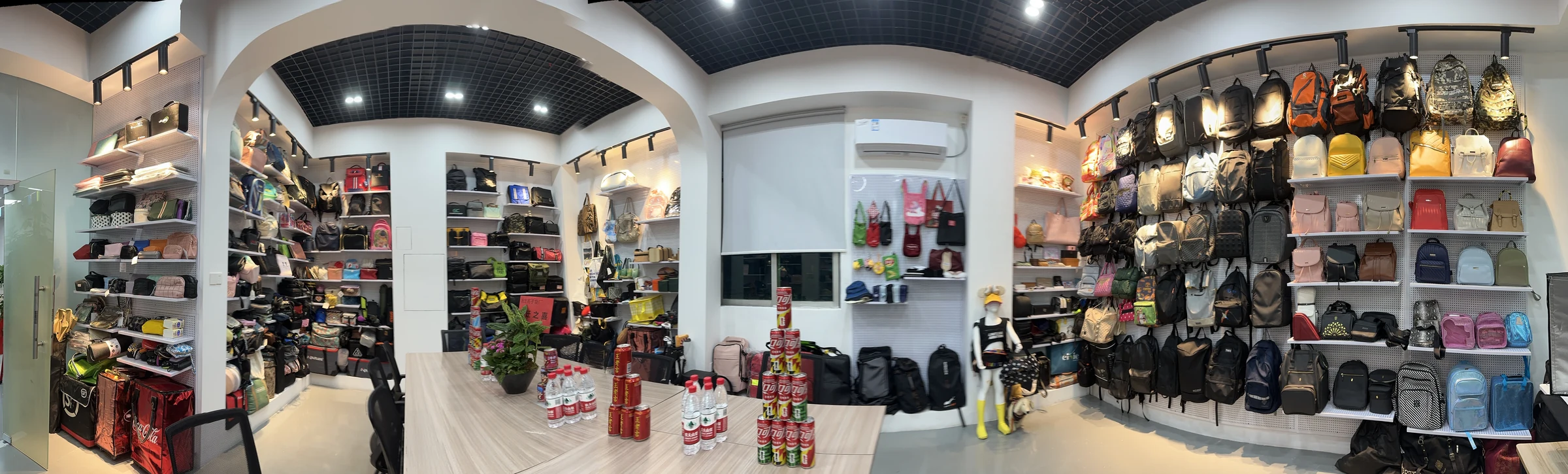 Real Hongzhao sample showroom displaying completed backpacks, handbags and promotional bags