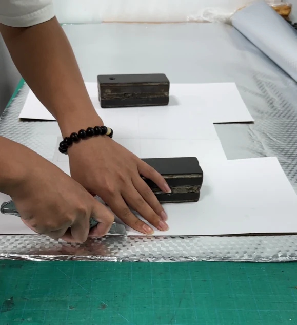 Real custom bag paper pattern cutting Owner-supplied photograph of paper bag patterns being cut before panel preparation