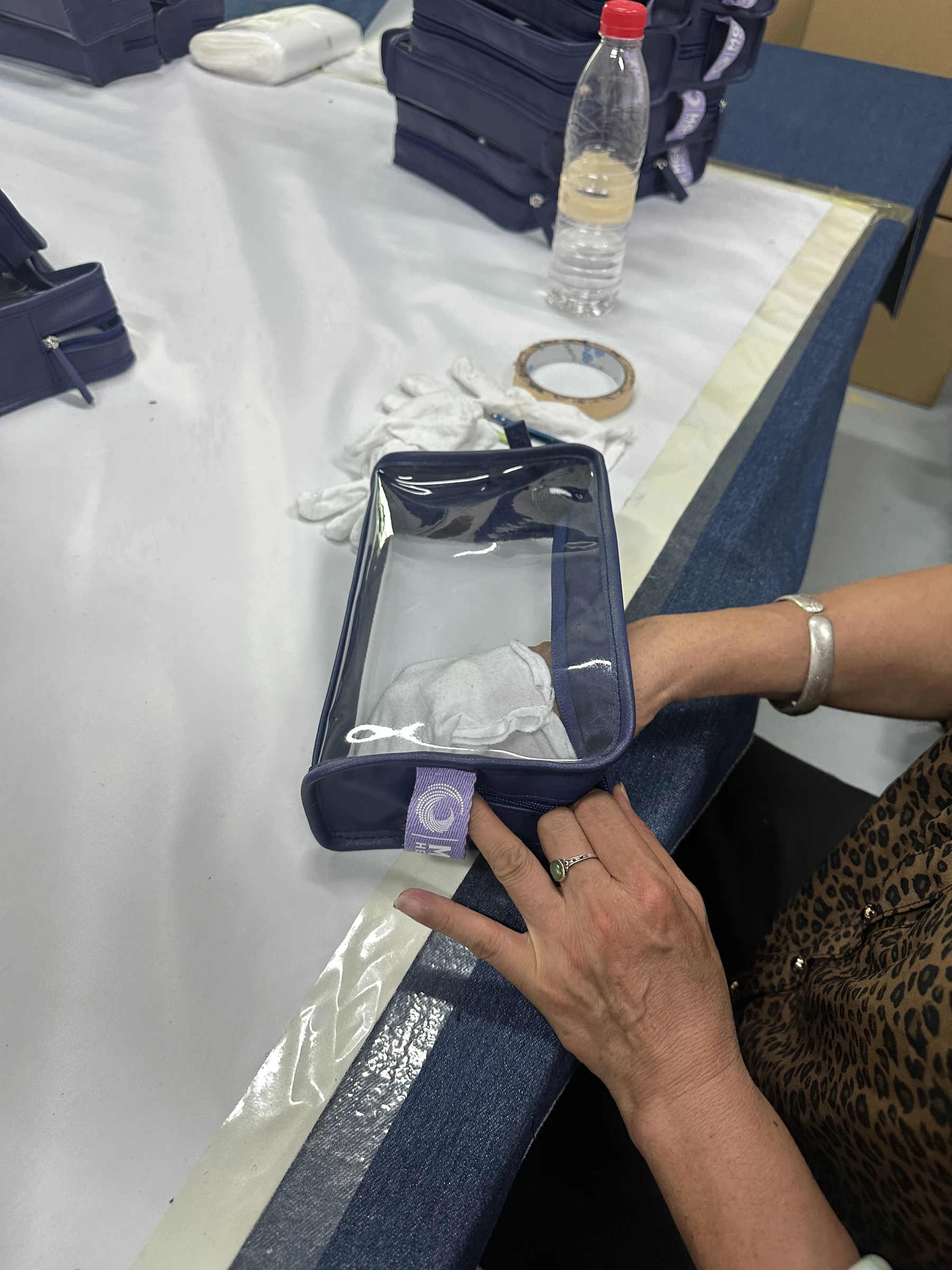 Real finished bag appearance inspection Owner-supplied photograph of a transparent cosmetic bag receiving an appearance check