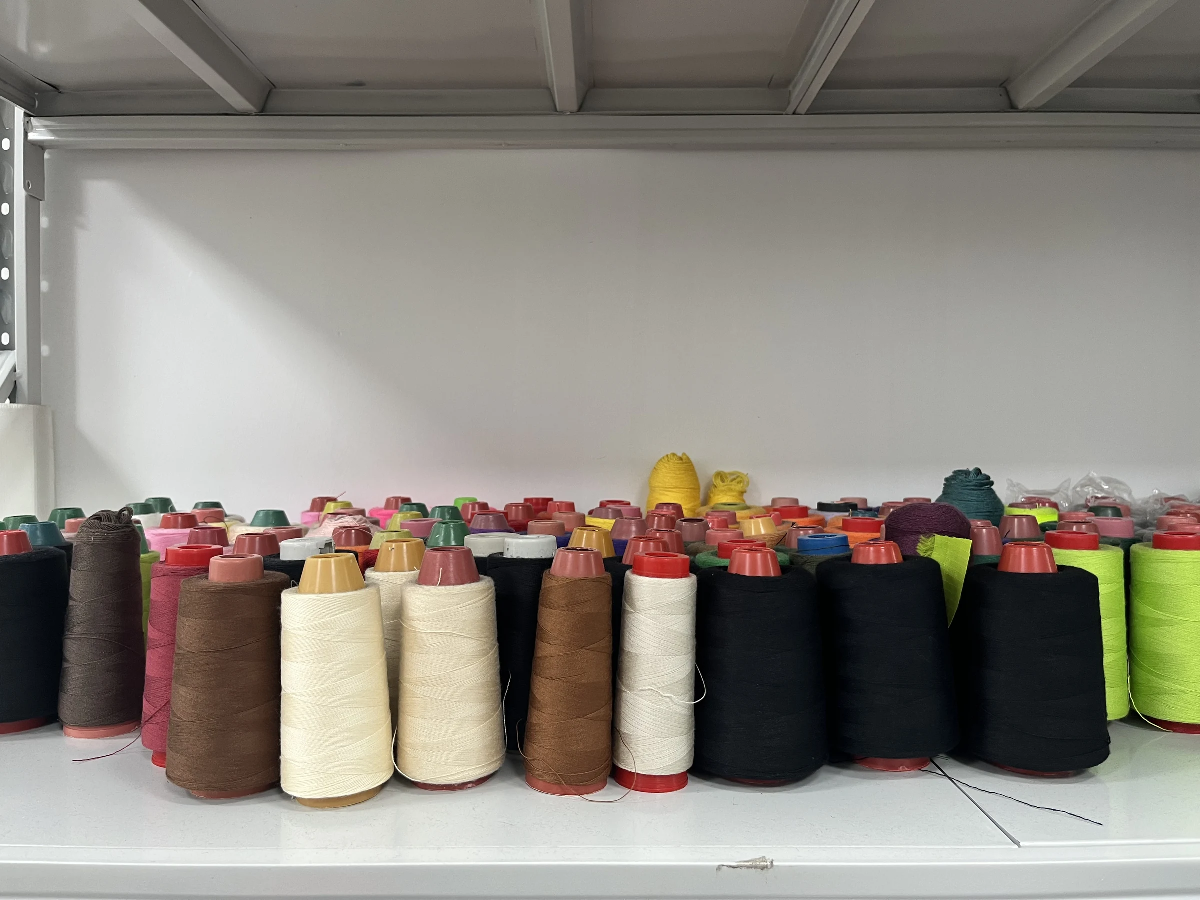 Real custom bag sewing thread selection Owner-supplied photograph of real sewing thread colors used in custom bag production
